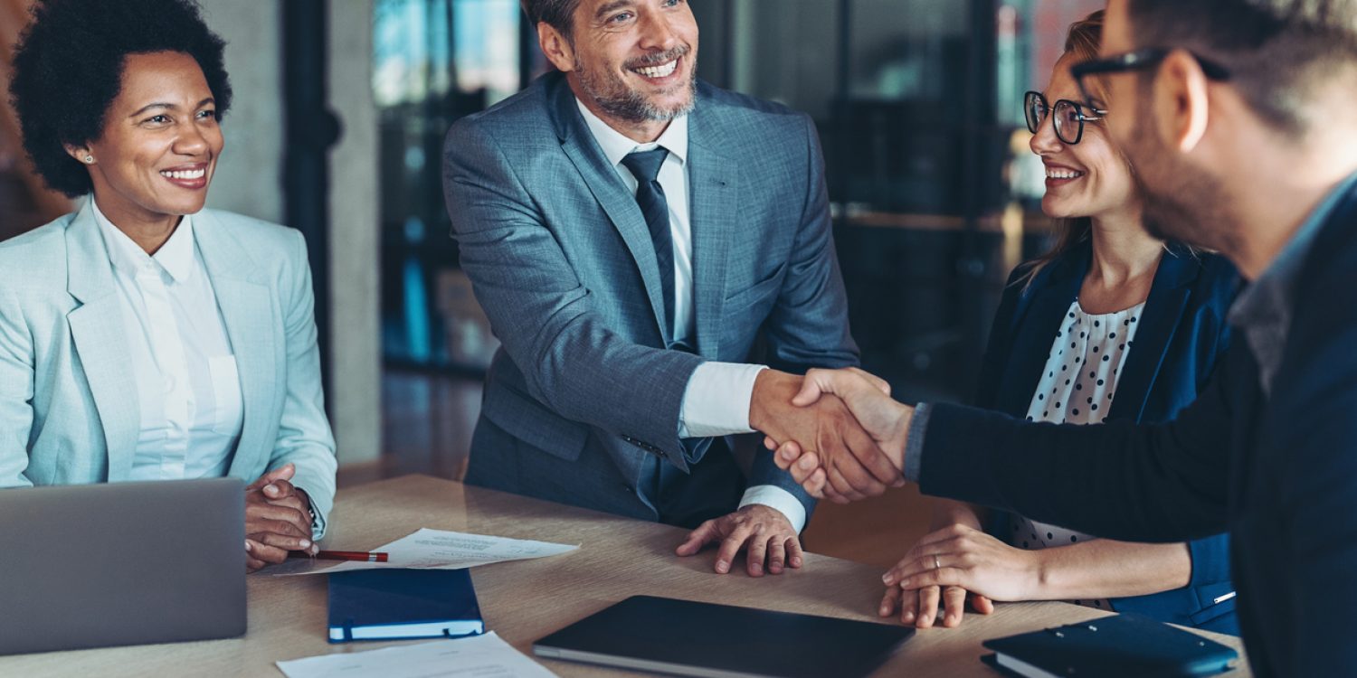 Two businessmen shaking hands in the office