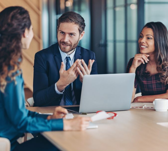 Group of business persons having a meeting in a modern office space